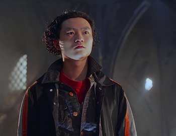 Movie still from “Doctor Who: The Movie” (1996), directed by Geoffrey Sax – A man in a black and red jacket looking to his left; Close Up shot, Low angle