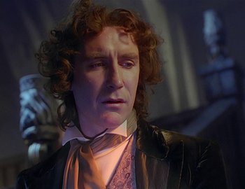 Movie still from “Doctor Who: The Movie” (1996), directed by Geoffrey Sax – A person wearing a suit and tie; Close Up shot, Over the shoulder angle