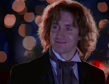 Movie still from “Doctor Who: The Movie” (1996), directed by Geoffrey Sax – A person wearing a suit and tie; Close Up shot, Over the shoulder angle