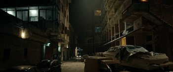 Movie still from “Dogman” (2018), directed by Matteo Garrone – An alley way in an urban setting at night; Extreme Wide shot, High angle