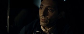 Movie still from “Dogman” (2018), directed by Matteo Garrone – A person wearing a suit and tie; Close Up shot, Over the shoulder angle