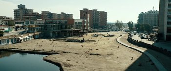 Movie still from “Dogman” (2018), directed by Matteo Garrone – An empty parking lot in the middle of a city; Extreme Wide shot, High angle