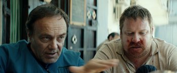 Movie still from “Dogman” (2018), directed by Matteo Garrone – Two men sitting in front of each other; Close Up shot, Over the shoulder angle