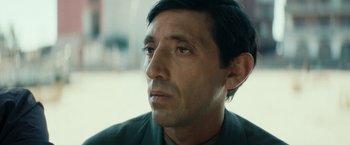 Movie still from “Dogman” (2018), directed by Matteo Garrone – A man's face looking to his left; Close Up shot, Over the shoulder angle