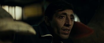 Movie still from “Dogman” (2018), directed by Matteo Garrone – A man's face in the dark; Close Up shot, Over the shoulder angle