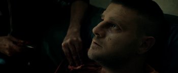 Movie still from “Dogman” (2018), directed by Matteo Garrone – A man is looking up at the ceiling; Close Up shot, High angle