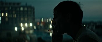 Movie still from “Dogman” (2018), directed by Matteo Garrone – A man is smoking a cigarette in the dark; Close Up shot, Low angle