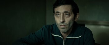 Movie still from “Dogman” (2018), directed by Matteo Garrone – A person wearing a jacket; Close Up shot, Low angle