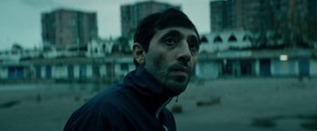 Movie still from “Dogman” (2018), directed by Matteo Garrone – A person wearing a jacket; Close Up shot, Low angle