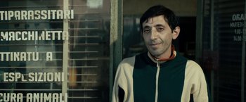 Movie still from “Dogman” (2018), directed by Matteo Garrone – A person standing near a window; Close Up shot, Over the shoulder angle