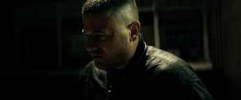 Movie still from “Dogman” (2018), directed by Matteo Garrone – A person wearing a black jacket; Close Up shot, Low angle