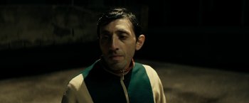 Movie still from “Dogman” (2018), directed by Matteo Garrone – A person wearing a jacket; Close Up shot, Over the shoulder angle