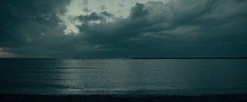 Movie still from “Dogman” (2018), directed by Matteo Garrone – A body of water under a cloudy dark sky; Extreme Wide shot, Low angle