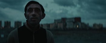 Movie still from “Dogman” (2018), directed by Matteo Garrone – A man in a black shirt and a black jacket; Close Up shot, Low angle