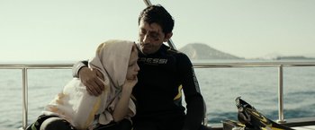 Movie still from “Dogman” (2018), directed by Matteo Garrone – A man and a child on a boat in the water; Medium shot, Over the shoulder angle
