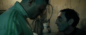 Movie still from “Dogman” (2018), directed by Matteo Garrone – A man and a woman face to face in a room; Close Up shot, Over the shoulder angle