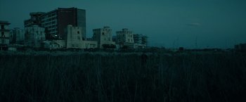 Movie still from “Dogman” (2018), directed by Matteo Garrone – A view of some buildings in the dark; Extreme Wide shot, Low angle