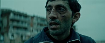 Movie still from “Dogman” (2018), directed by Matteo Garrone – A person wearing a black jacket; Close Up shot, Low angle