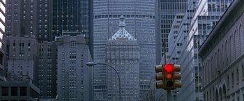 Movie still from “Dolores Claiborne” (1995), directed by Taylor Hackford – A traffic light sitting on the side of a building; Extreme Wide shot, Low angle
