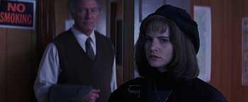 Movie still from “Dolores Claiborne” (1995), directed by Taylor Hackford – A man and a woman standing next to each other in a room; Close Up shot, Over the shoulder angle