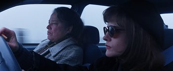 Movie still from “Dolores Claiborne” (1995), directed by Taylor Hackford – Two women sitting in the back seat of a car; Close Up shot, Low angle