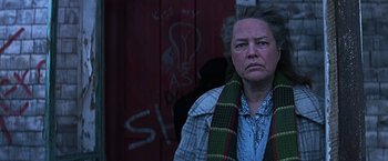 Movie still from “Dolores Claiborne” (1995), directed by Taylor Hackford – An older woman wearing a scarf and a jacket; Close Up shot, Low angle