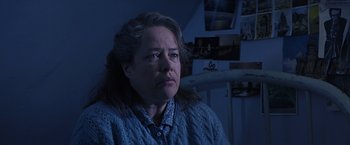 Movie still from “Dolores Claiborne” (1995), directed by Taylor Hackford – An older woman sitting in front of a wall; Close Up shot, Low angle