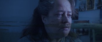 Movie still from “Dolores Claiborne” (1995), directed by Taylor Hackford – A woman with long black hair is looking at the camera; Close Up shot, Low angle