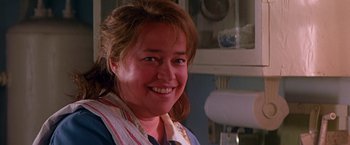 Movie still from “Dolores Claiborne” (1995), directed by Taylor Hackford – A person smiling for the camera; Close Up shot, Over the shoulder angle