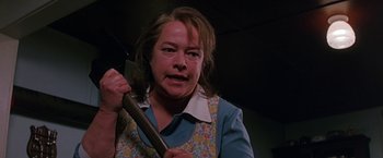 Movie still from “Dolores Claiborne” (1995), directed by Taylor Hackford – A woman holding a knife in her hand; Close Up shot, Low angle