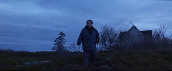 Movie still from “Dolores Claiborne” (1995), directed by Taylor Hackford – A man is walking in a field at night; Wide shot, Low angle