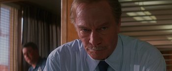 Movie still from “Dolores Claiborne” (1995), directed by Taylor Hackford – An older man wearing a white shirt and a blue tie; Close Up shot, Low angle