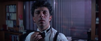 Movie still from “Dolores Claiborne” (1995), directed by Taylor Hackford – A person tying a tie; Close Up shot, Low angle