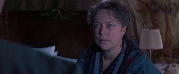 Movie still from “Dolores Claiborne” (1995), directed by Taylor Hackford – A person wearing a scarf looking at the camera; Close Up shot, Over the shoulder angle