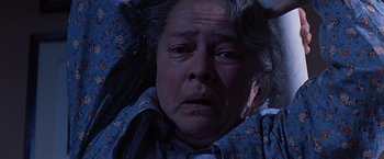 Movie still from “Dolores Claiborne” (1995), directed by Taylor Hackford – An older woman is looking at the camera; Close Up shot, High angle