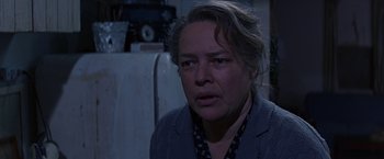 Movie still from “Dolores Claiborne” (1995), directed by Taylor Hackford – An older woman is looking at the camera; Close Up shot, Over the shoulder angle