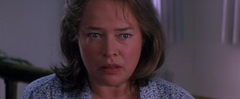 Movie still from “Dolores Claiborne” (1995), directed by Taylor Hackford – A woman's face in a blue shirt; Close Up shot, Low angle