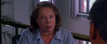 Movie still from “Dolores Claiborne” (1995), directed by Taylor Hackford – A person sitting in a room; Close Up shot, Over the shoulder angle