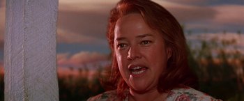 Movie still from “Dolores Claiborne” (1995), directed by Taylor Hackford – A woman's face in a field; Close Up shot, Low angle