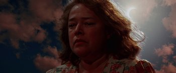 Movie still from “Dolores Claiborne” (1995), directed by Taylor Hackford – A woman's face in front of a cloudy sky; Close Up shot, Low angle