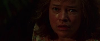 Movie still from “Dolores Claiborne” (1995), directed by Taylor Hackford – A woman's face in the dark; Close Up shot, Low angle
