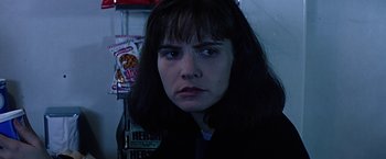 Movie still from “Dolores Claiborne” (1995), directed by Taylor Hackford – A person in a dark room; Close Up shot, Over the shoulder angle