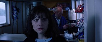 Movie still from “Dolores Claiborne” (1995), directed by Taylor Hackford – A woman sitting in front of an older man in a restaurant; Close Up shot, Over the shoulder angle