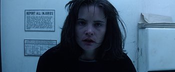 Movie still from “Dolores Claiborne” (1995), directed by Taylor Hackford – A woman with long dark hair stares into the camera; Close Up shot, Low angle