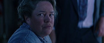 Movie still from “Dolores Claiborne” (1995), directed by Taylor Hackford – An older woman looking at the camera in a dark room; Close Up shot, Over the shoulder angle