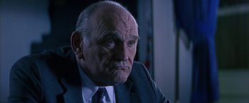 Movie still from “Dolores Claiborne” (1995), directed by Taylor Hackford – An older man wearing a suit and tie; Close Up shot, Low angle