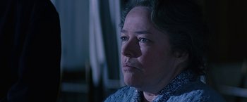 Movie still from “Dolores Claiborne” (1995), directed by Taylor Hackford – An older woman with blue eyes stares into the distance; Close Up shot, Over the shoulder angle