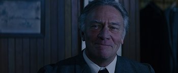 Movie still from “Dolores Claiborne” (1995), directed by Taylor Hackford – An older man wearing a suit and tie in a room; Close Up shot, Low angle