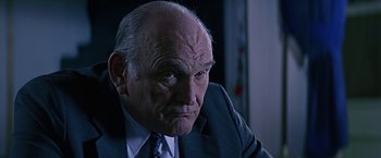 Movie still from “Dolores Claiborne” (1995), directed by Taylor Hackford – An older man wearing a suit and tie; Close Up shot, Low angle