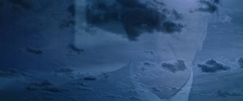 Movie still from “Dolores Claiborne” (1995), directed by Taylor Hackford – A view of a cloudy sky with a person's face in the sky; Extreme Close Up shot, Low angle